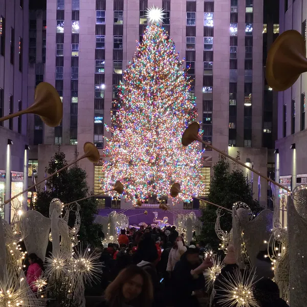 Rockefeller Center Christmas tree and illuminated angels at night.